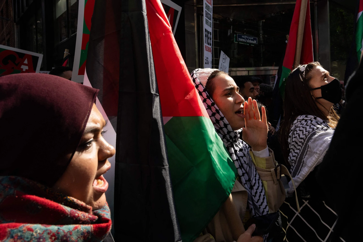 Muslim supporters holding Palestinian flags at a solidarity demonstration